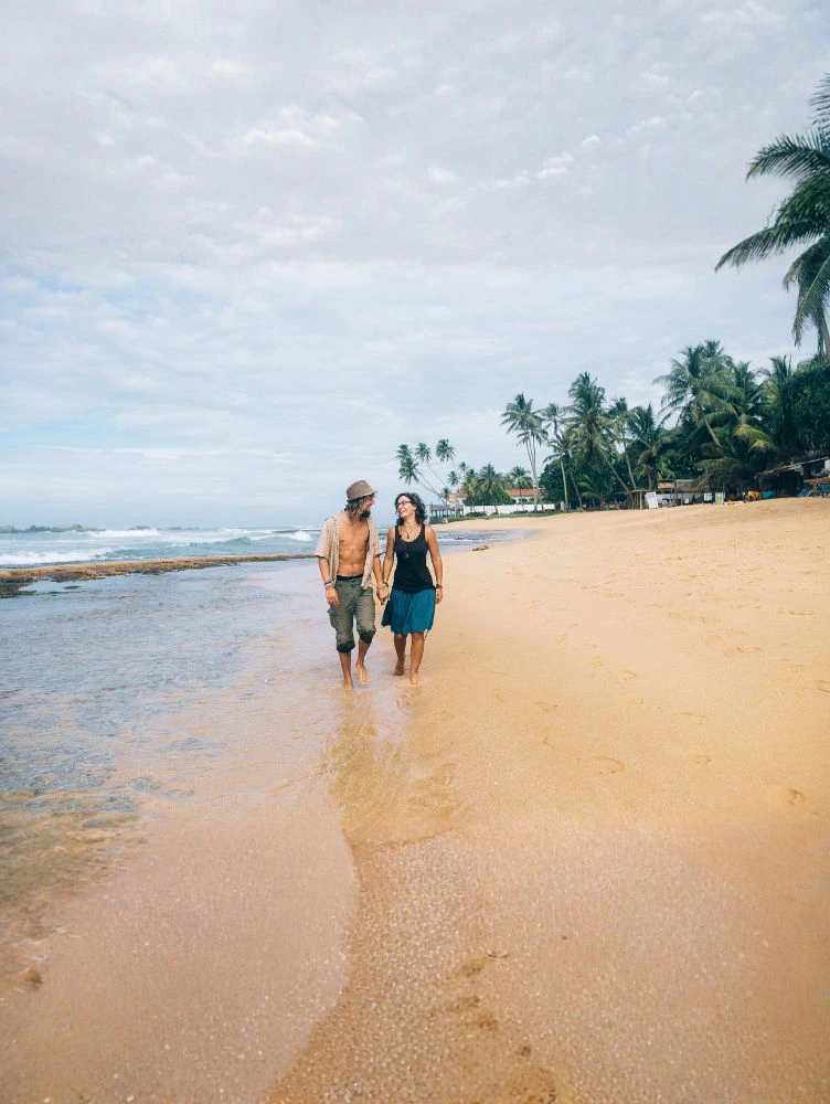 Romantic beach walk in Varkala with palm trees and ocean views